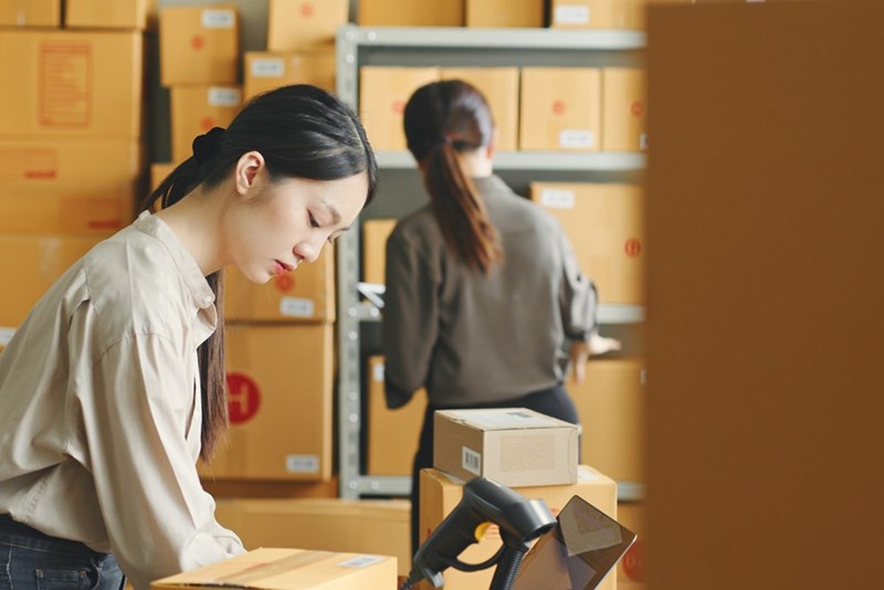 A woman works at a warehouse