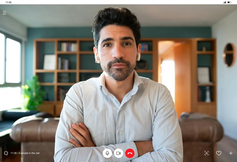 A screenshot of the young professional folding his arms while participating in his interview.