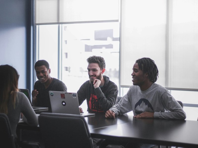A group of men sit in a conference room
