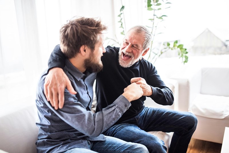 Caregiver and grandfather spend time together at home.