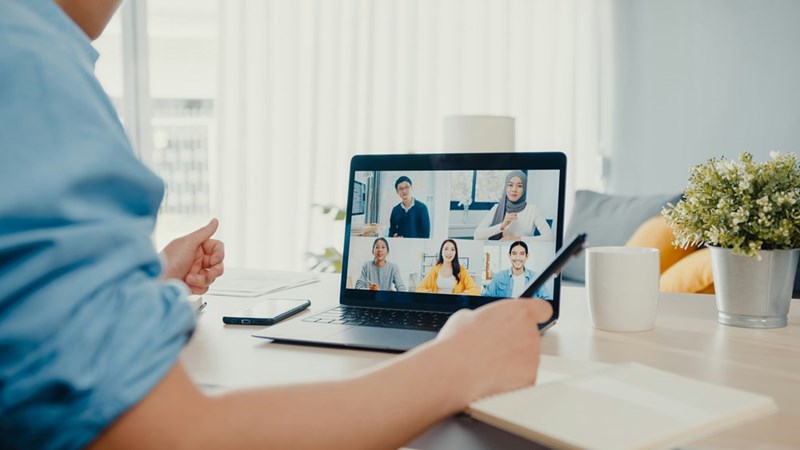 A remote worker gestures while on a video conference call