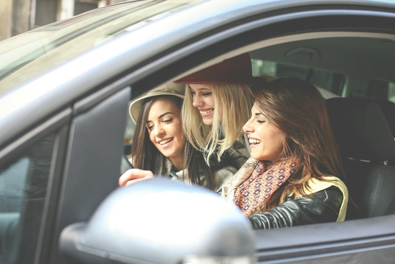 Group of young women enjoying a fun road trip together.