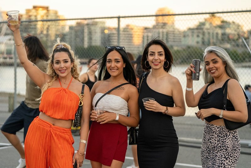 A group of women stand next to each other on the tennis court