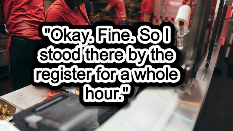 A worker prepares a fast-food burger at a fast-paced restaurant.