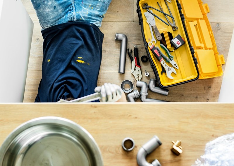 A man doing home repairs at an elderly neighbor's house.