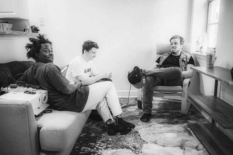 A group of young men sitting around a living room together