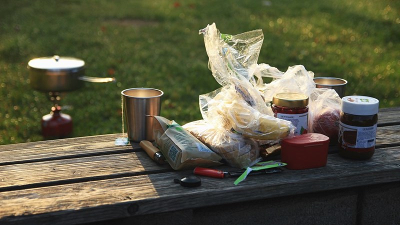 Camping food and supplies packed for a weekend lake trip.