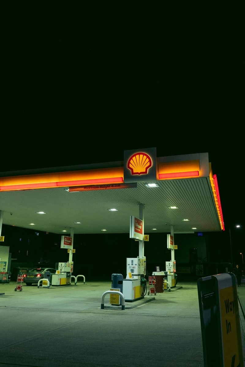 A car parked at a fuel station.