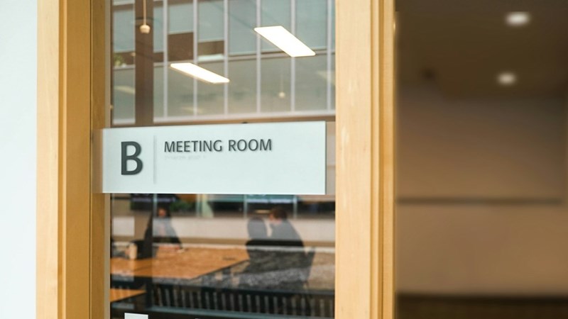 A clearly marked meeting room in a professional office workspace