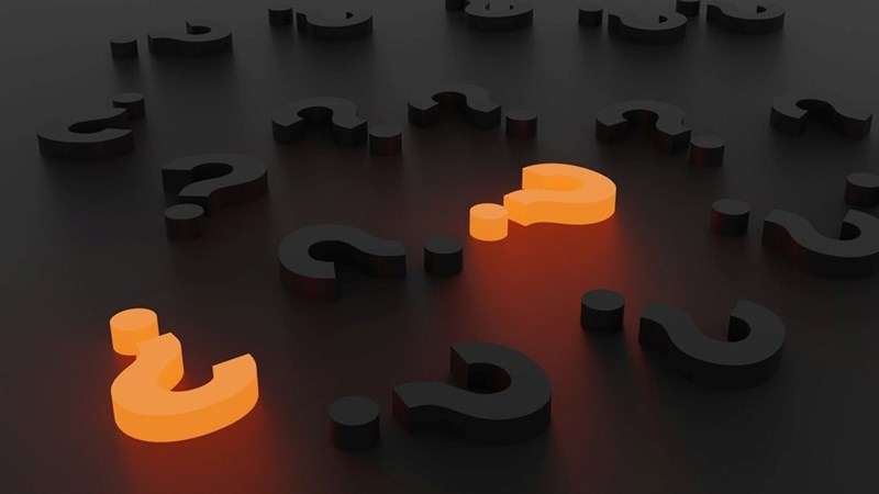 Question marks against a dark background