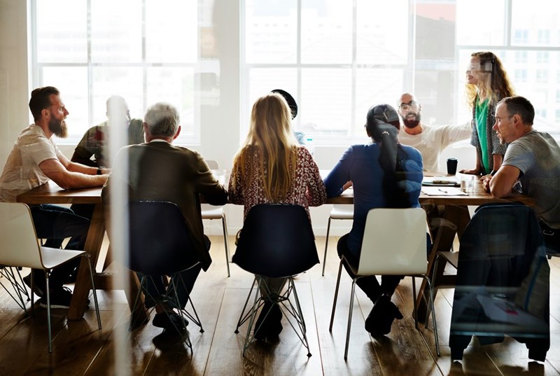 A group of people sit in a conference room