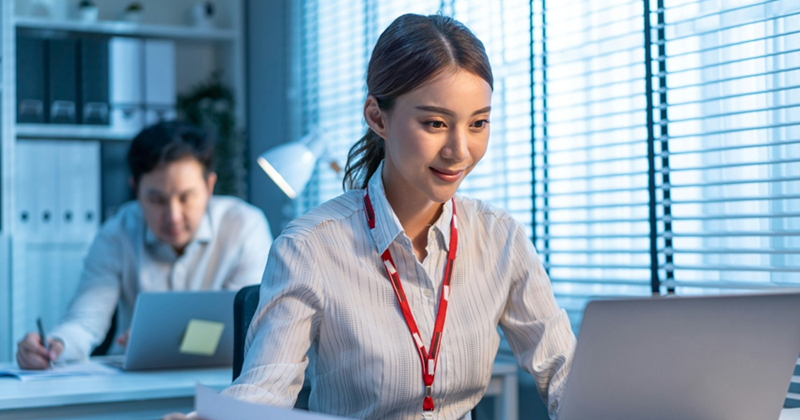 A female employee works on her laptop in the office