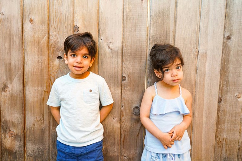 Two children standing next to each other