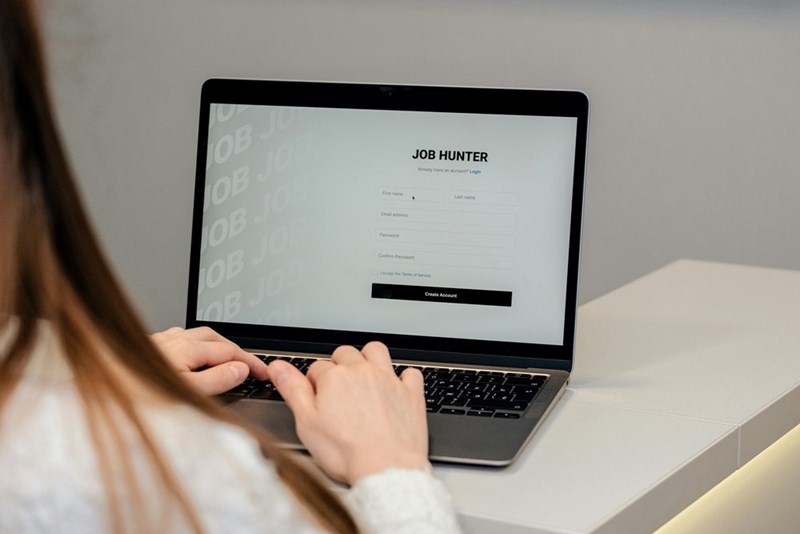 A recruiter types on a laptop with “Job Hunter” on the screen.