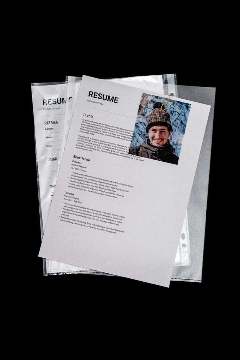 A portrait of a male candidate's resume with his photo in the top right corner.