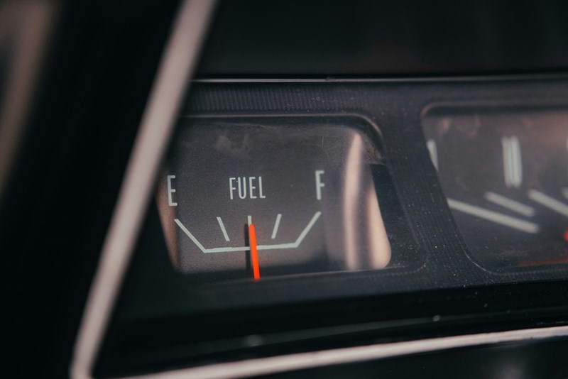 Fuel gauge showing empty tank with low fuel warning.