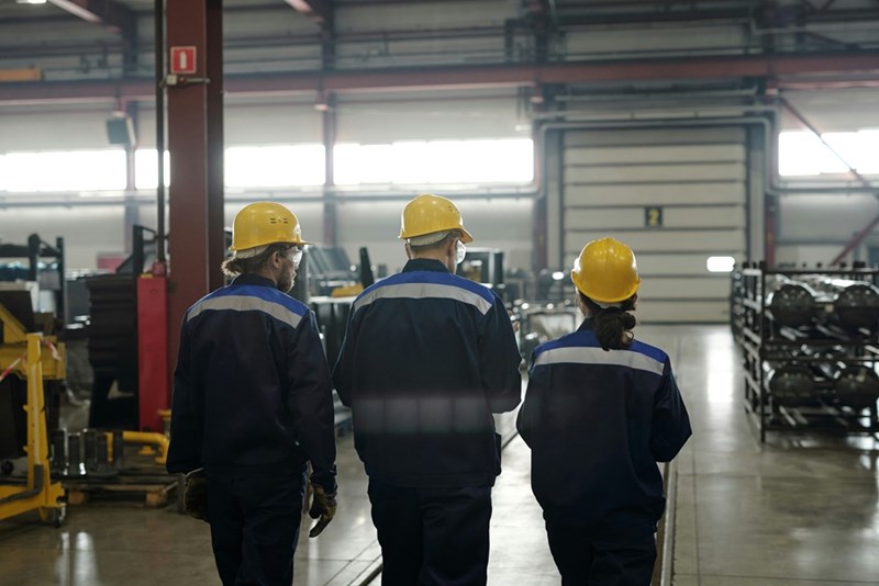 Industrial workers work together on shift.