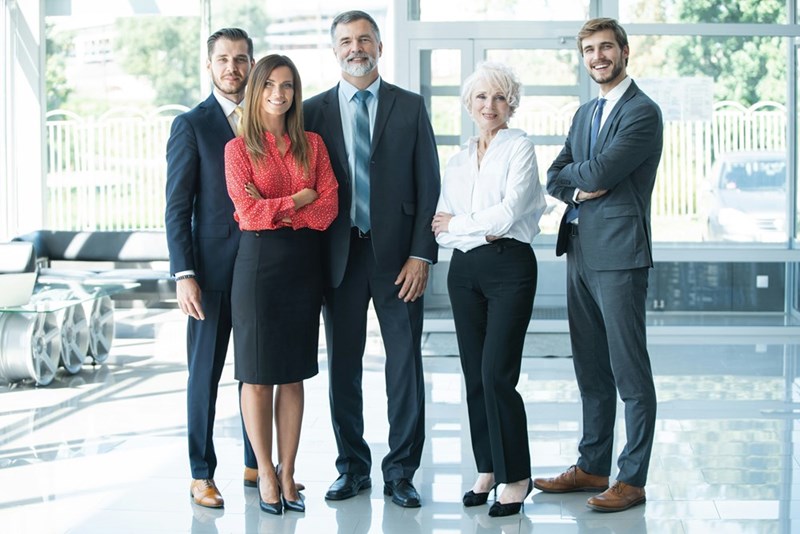 Group of businesspeople standing together in office.