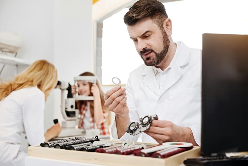Jewelry store worker checking ring with a microscope.