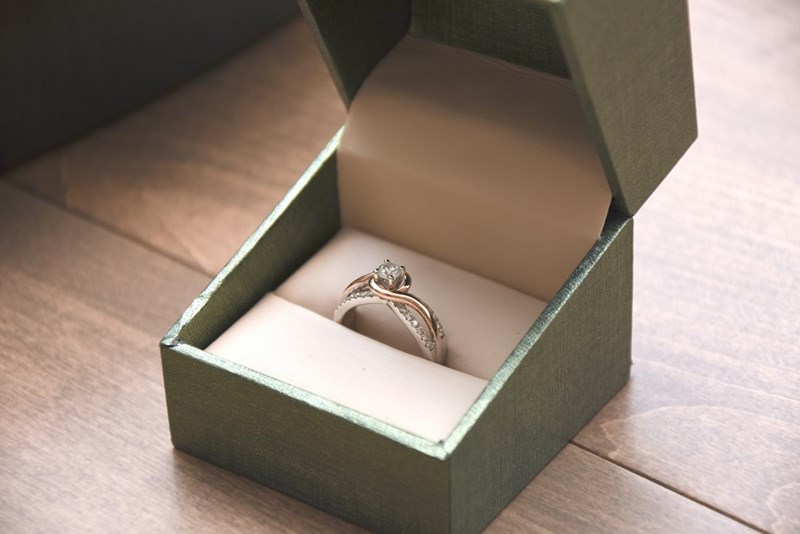 Engagement ring on a green box.