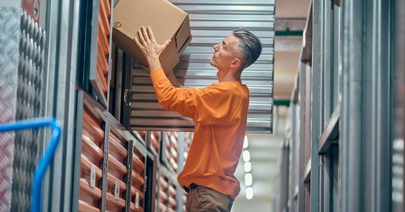 A representation of a customer removing a box from his private storage unit.
