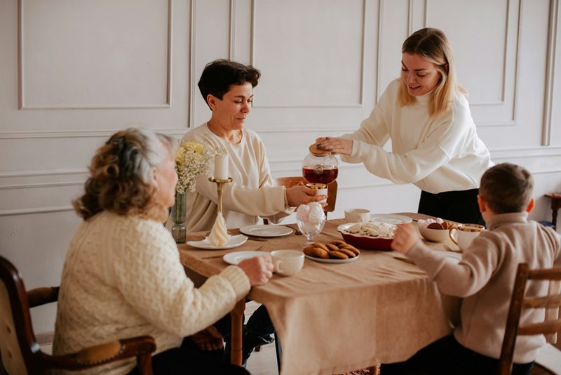 A family sits around a table eating dinner