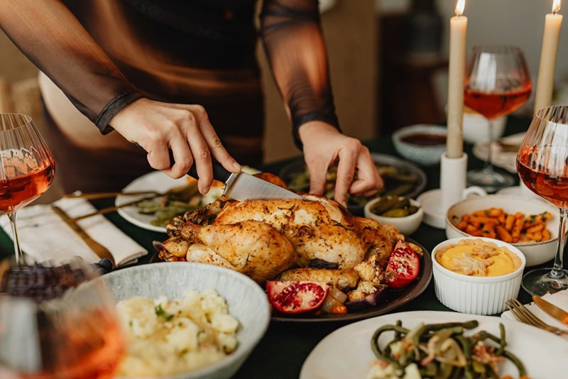 Woman serving a meal cooked by herself for her in-laws.