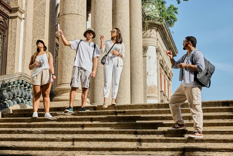 The group explores some architecture and ask their guide questions about the location.