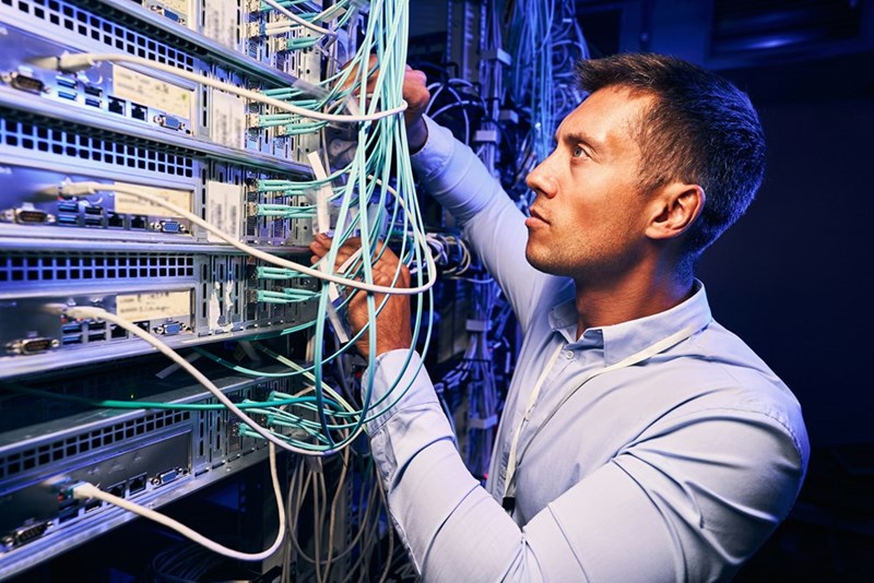 Representation of an IT worker looking through wire bundle right before he quits.