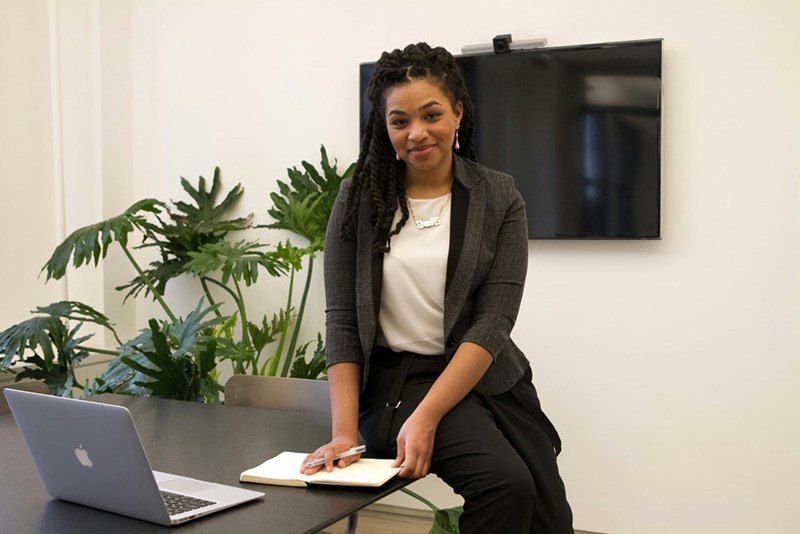 Model depicting a plant worker who is holding a 20-person meeting alone in a conference room, smiling broadly at the successful plan.
