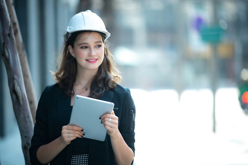 A photo of a model representing a 25-year-old woman working overtime at her new full-time job.