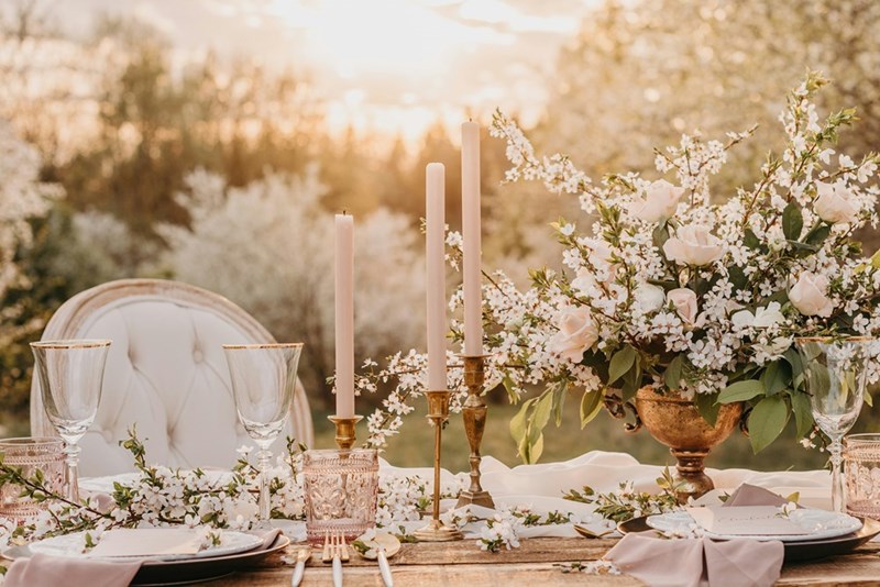 Celebration dinner place setting with flowers and candles as shown in a depiction.