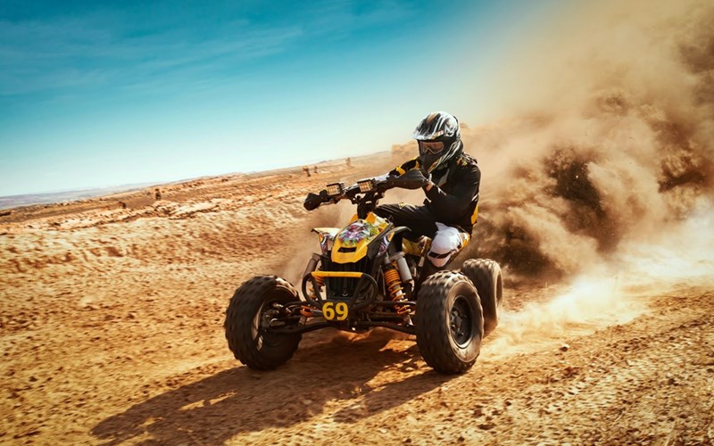 Quad rider enjoying an outdoor motorsports activity with family appeal