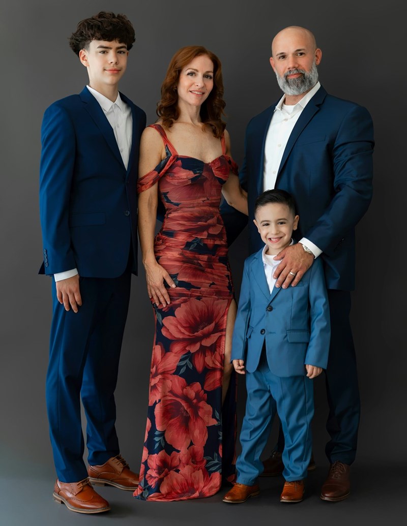 Teenage son tries to decide what to do with his lottery winnings as he stands with his Mom, Dad, and sibling, as represented by models.