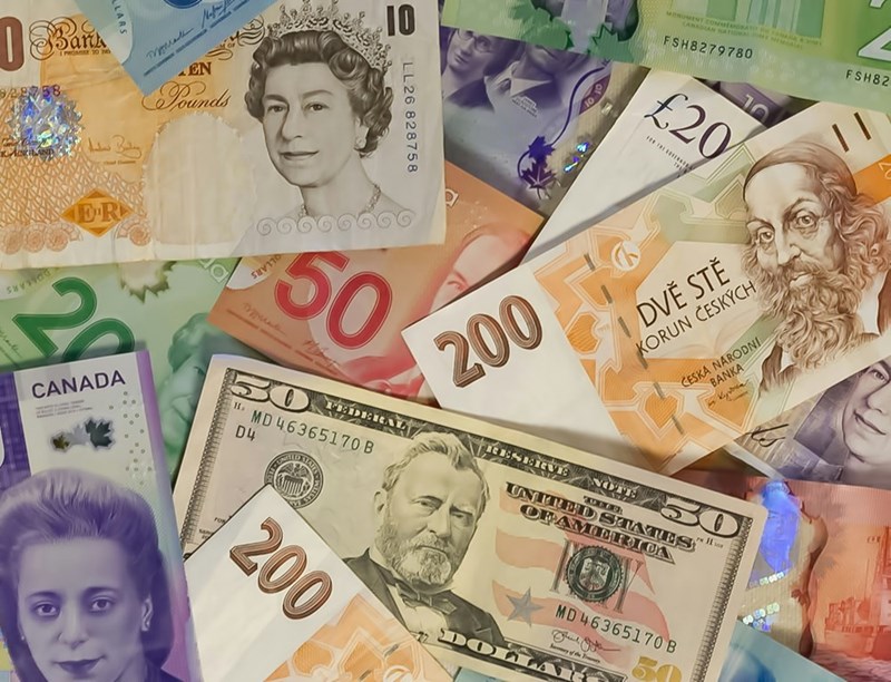 Different types of currency, including US dollars and British pounds, in a representation.