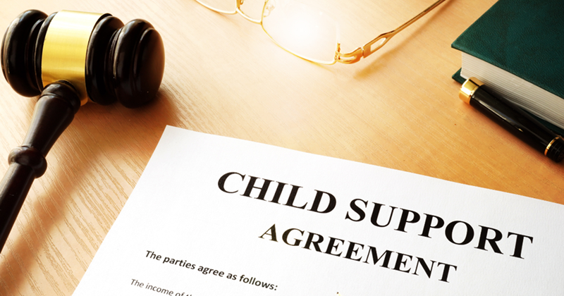 Document titled ‘child support agreement’, next to glasses and a gavel.