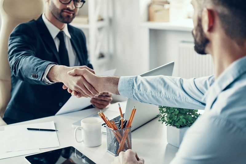 Hiring manager welcomes a new employee following the hiring process.