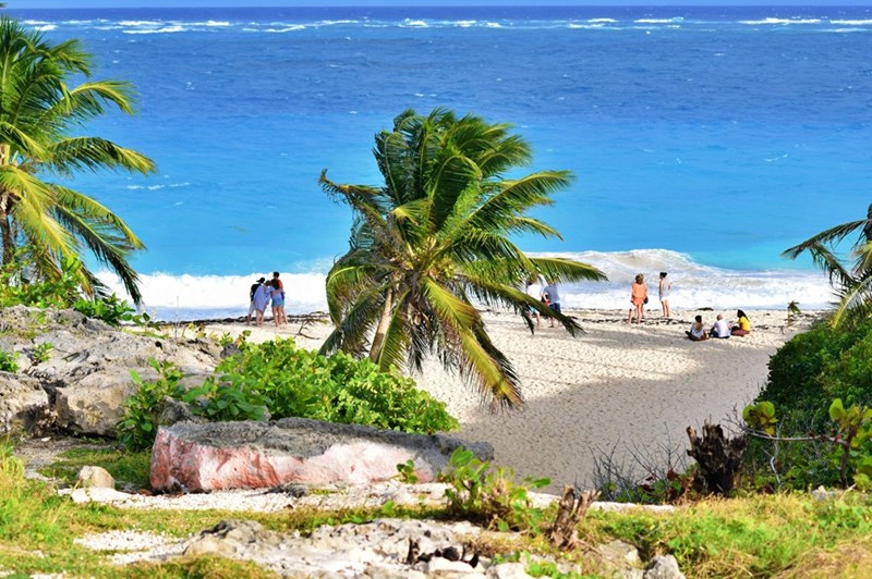 Vacationers enjoy a Caribbean beach day, as depicted by models.