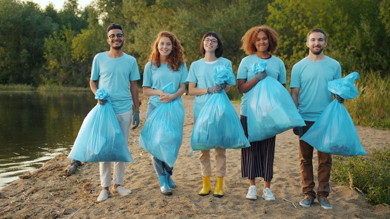 Group of teens with filled-up trash bags following their 4-hour shift, in a demonstration from 5 models.