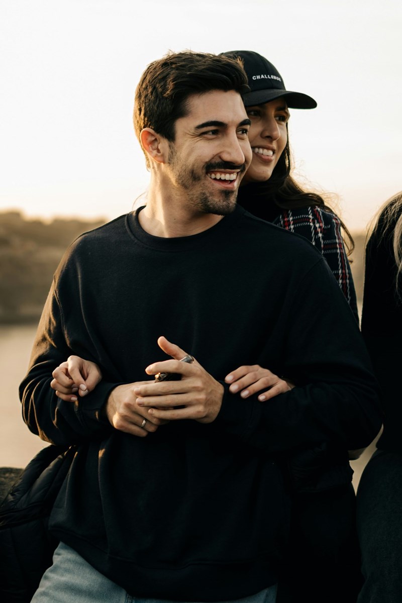 A portrait of a man at a bachelor party embracing a woman. Subjects are models.
