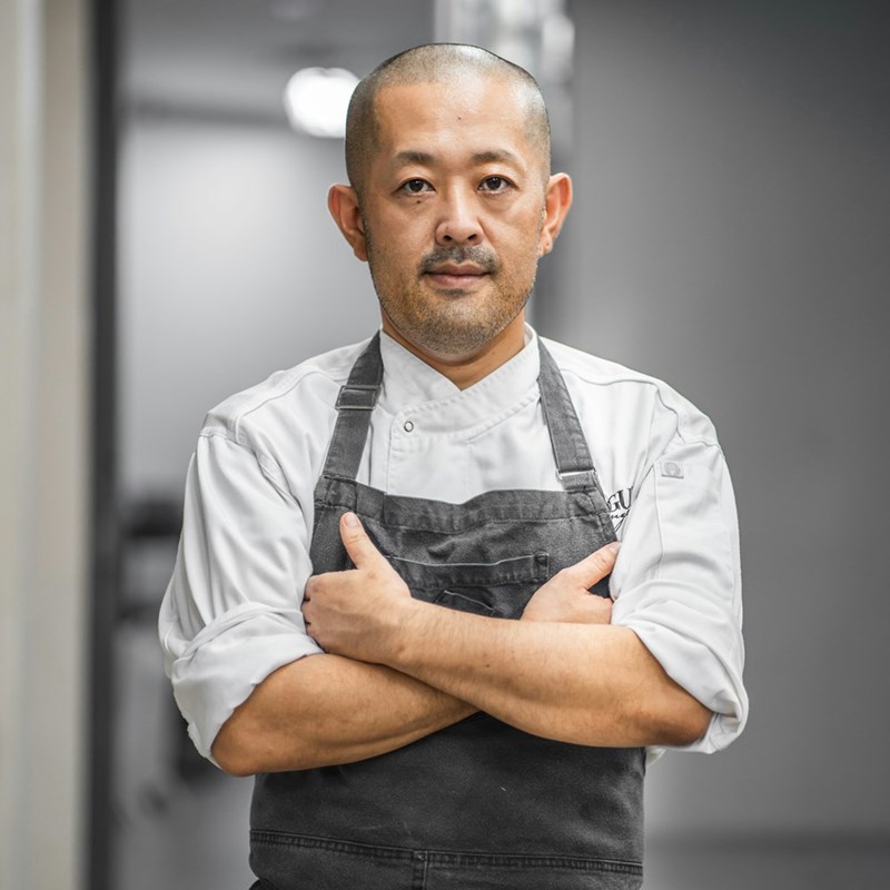 Chef folds arms and displays a disgruntled expression after realizing the boss has taken away free lunches, as depicted by a model.