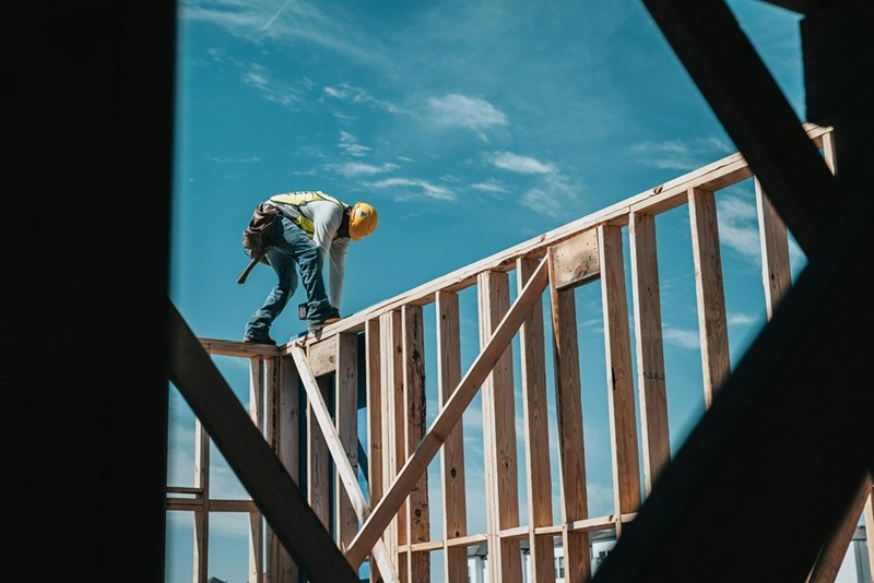 Construction worker in a hard hat on a building frame