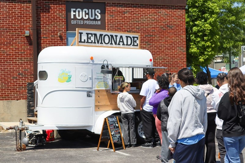 Customers queue up to try a viral beverage, as demonstrated by models.