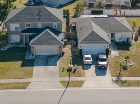 A representation of a homeowner's unused driveway next to a neighbor's crowded driveway with two parked cars.