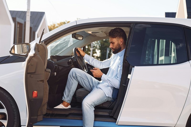 A homeowner waiting for his neighbor to move their car so that he can park in his own driveway.