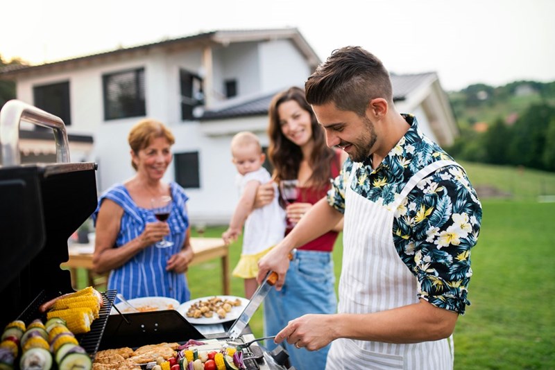 Family attends a backyard BBQ, in a representation from models.