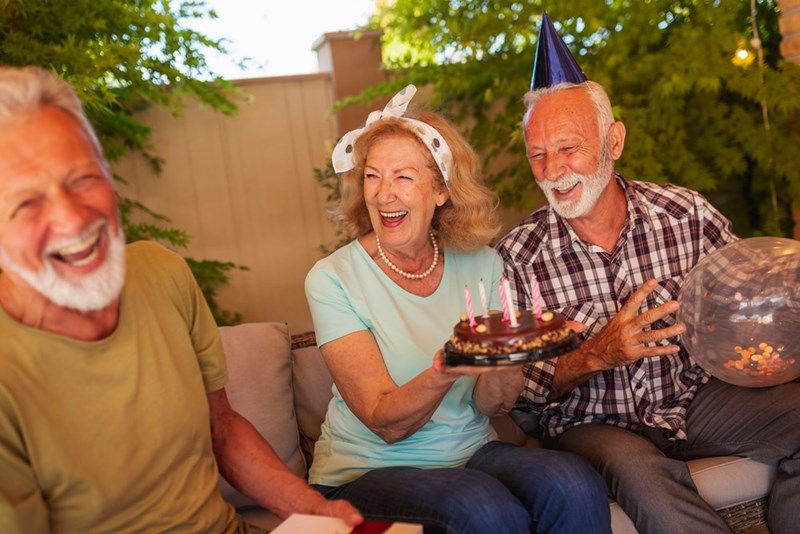 Neighbors spending time with friends in their backyard, with their oak trees visible in the background, as shown in a depiction by 3 models.