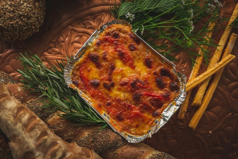 A photo representing a dish of lasagna on an elegant table.