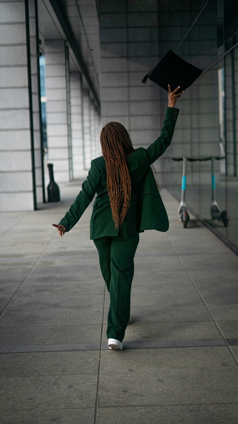a woman in a suit leaving a building