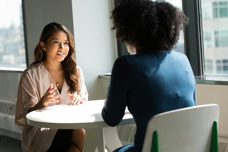 Models showcasing a conversation between two women